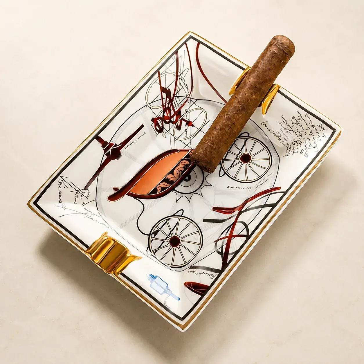 Cigar Ashtray — carriage sketch product view Product view of sketch-art ceramic cigar ashtray with gold rests on marble