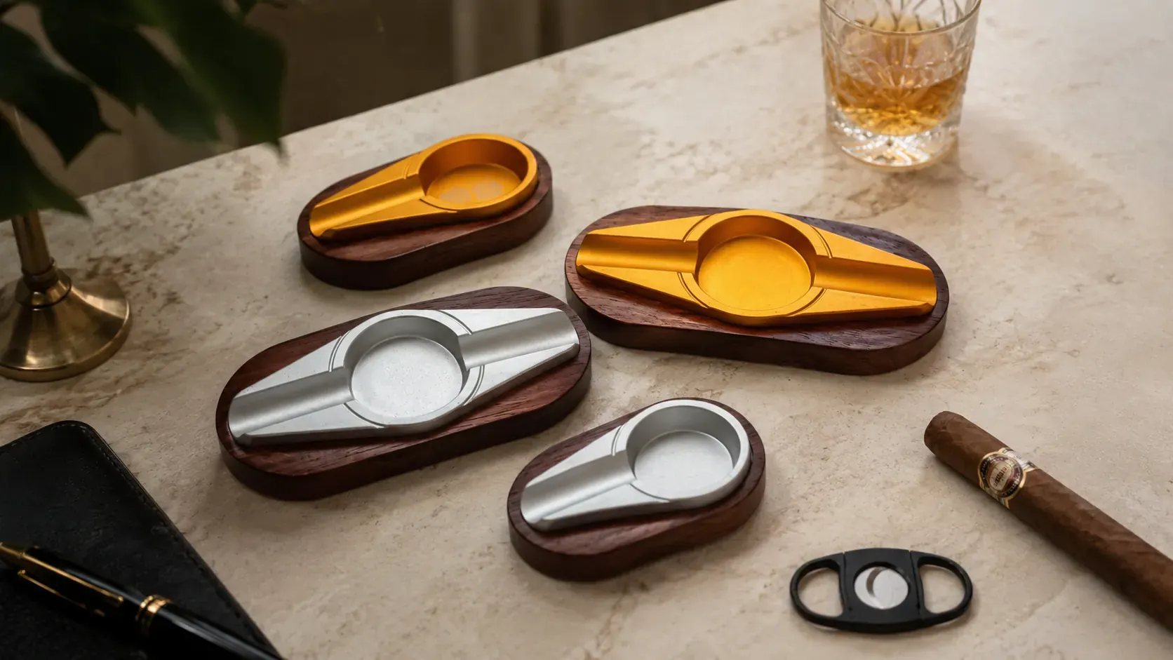 High-end classic hardwood cigar ashtrays with gold- and silver-finish aluminium inserts, staged with whiskey, cigar, and cutter High-end classic hardwood cigar ashtrays with gold- and silver-finish aluminium inserts, staged with whiskey, cigar, and cutter