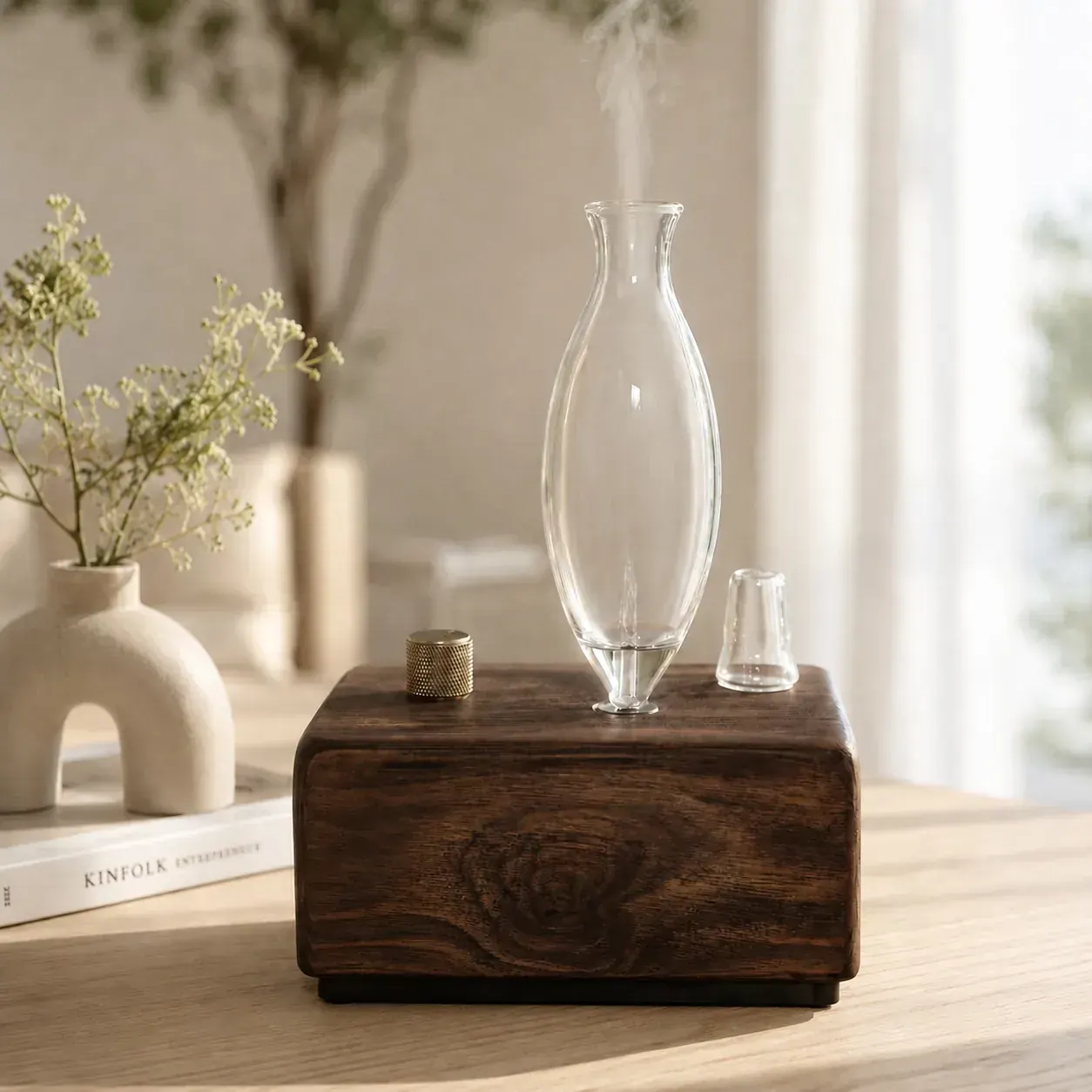Dual-Fluid Aroma Diffuser — tall glass vessel with mist Dark hardwood dual-fluid aroma diffuser with tall glass vessel releasing aromatic mist