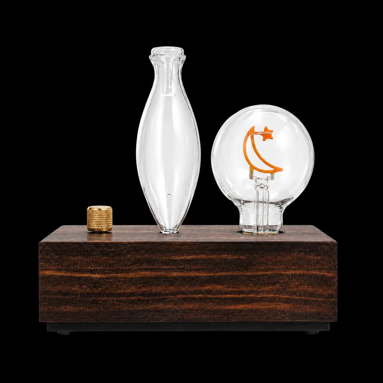 Dark wood dual-fluid aroma diffuser with oval glass vessel and moon-filament sphere Dark wood dual-fluid aroma diffuser with oval glass vessel and moon-filament sphere