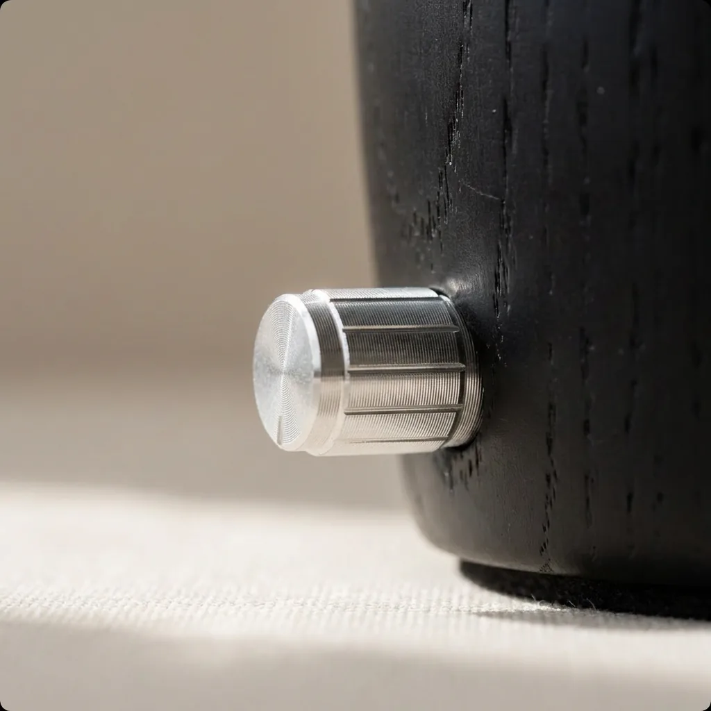 Dual-Fluid Aroma Diffuser — knurled metal control knob Knurled silver metal control knob set into a dark wood dual-fluid aroma diffuser base