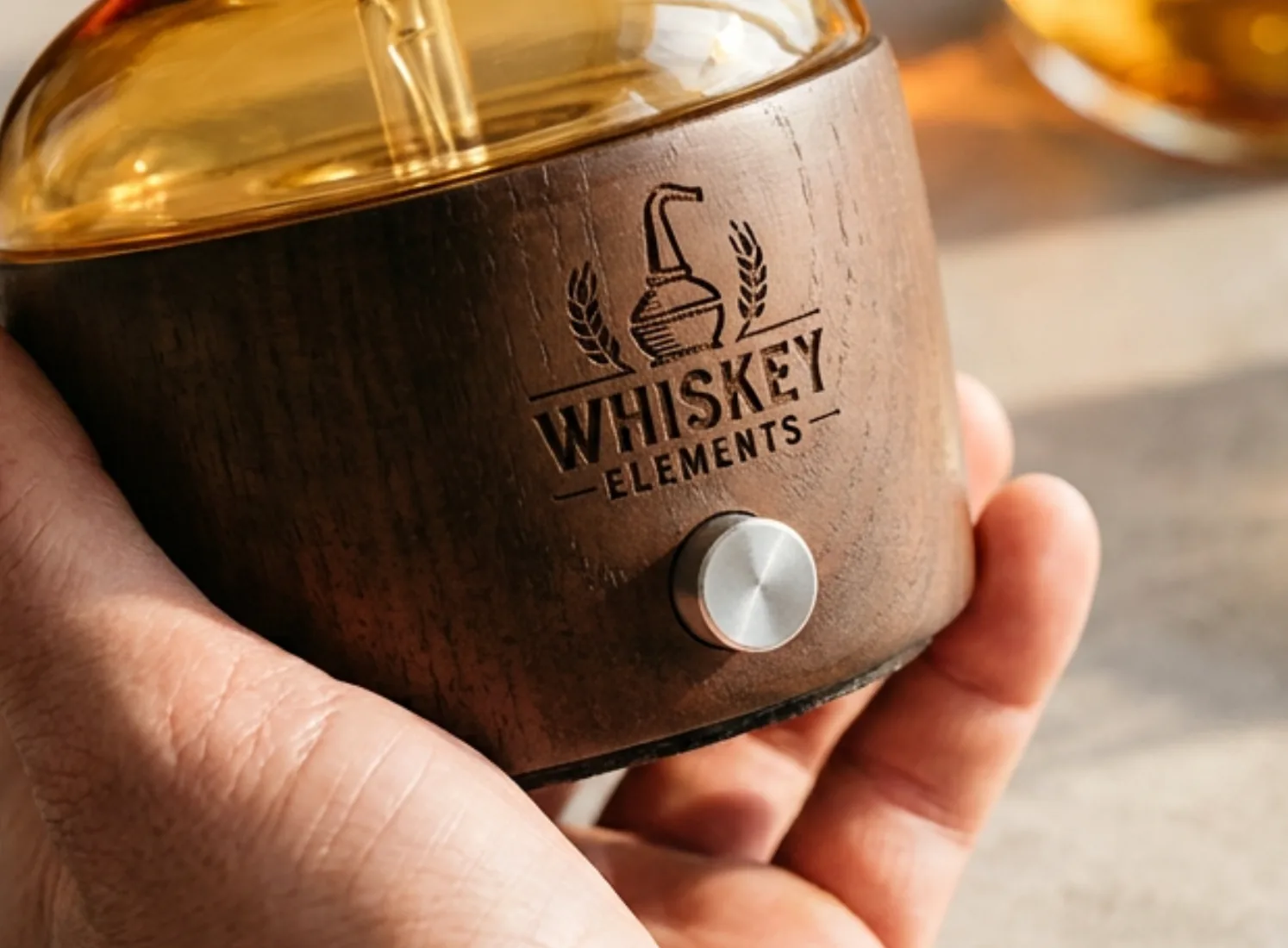 Dual-Fluid Aroma Diffuser — one-unit sample with logo Hand holding a dark wood dual-fluid aroma diffuser base with a laser-engraved brand logo for one-unit ODM review