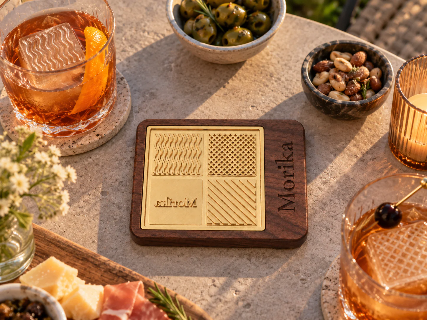 Ice branding stamp on a tasting table with cocktails, olives, and charcuterie Ice branding stamp on a tasting table with cocktails, olives, and charcuterie